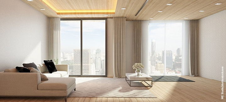 Wohnzimmer mit holzgetäfelter Decke, Wand, Holzpaneelböden, großem Sofa und Tisch mit Blumenvase. Panoramafenster mit Blick auf Innenstadt-Wolkenkratzer.